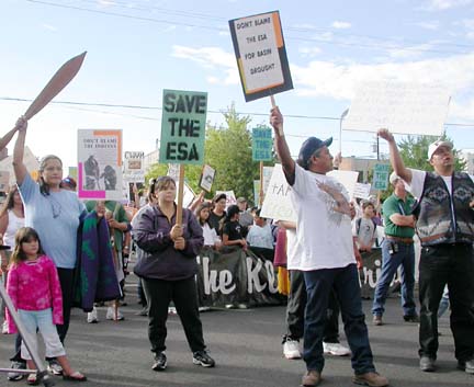 [tribal members holding signs saying "save the ESA"]