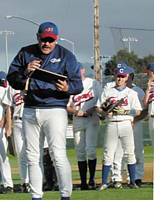 Coach Shorty Ames with microphone and plaque