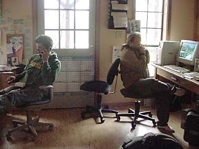 Harling and Riggan talking on telephones at their desks