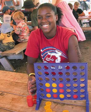 [Jazzmine with "Connect Four" game in kids tent]
