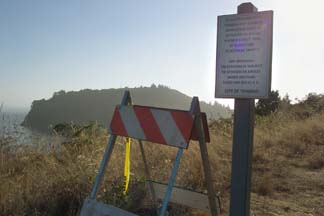 Trail head with barricade and warning sign