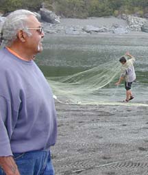 Photo of Corky Simms watching fish netting and tagging