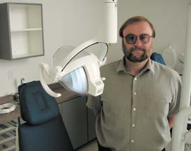 Hermann Spetzler standing inside mobile dental clinic