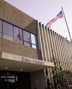 [Entrance to Times-Standard building, sign and American flag]