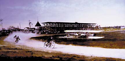hand-colored photo of motorcycle race on track with biplane and spectator stands in background