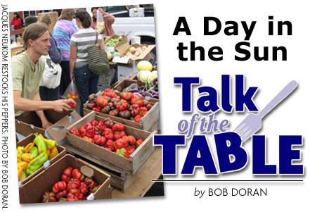 HEADING: Talk of the Table, A Day in the Sun, by Bob Doran. Photo of JACQUES NEUKOM RESTOCKING HIS PEPPERS