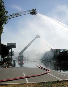 ladder truck pumping water from above into the fire