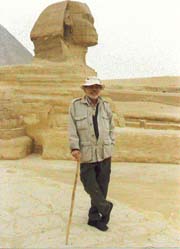 John Anthony West leaning on his cane in front of the Sphinx