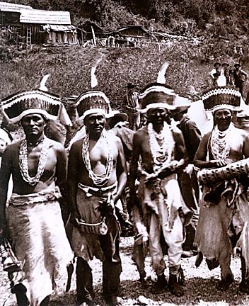 [Historical photo of four Hupa dancers]