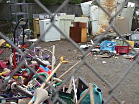 Storage yard of St. Vincent De Paul in Arcata, showing appliances and kids bikes and other garbage