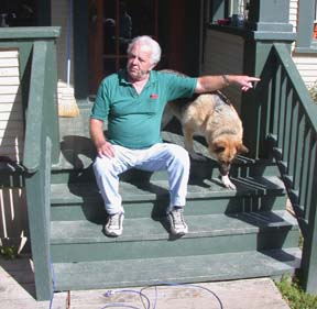 Kallo and dog sitting on porch of house