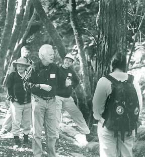 photo of Rondall Snodgrass leading hike in the woods