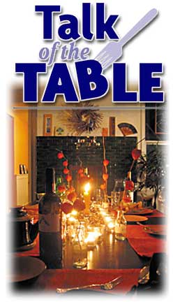 Heading: Talk of the Table, photo of table set for a holiday dinner