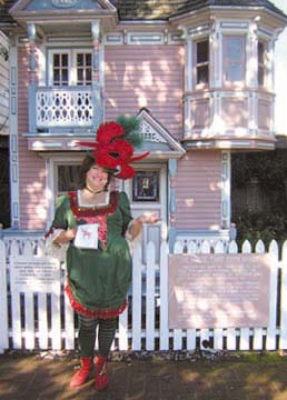 [Elf Ellie standing in front of miniature house]