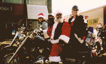 [photo of bikers on motorcycles, one dressed as Santa]