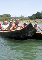 [Wiyot tribal members on canoes in bay]